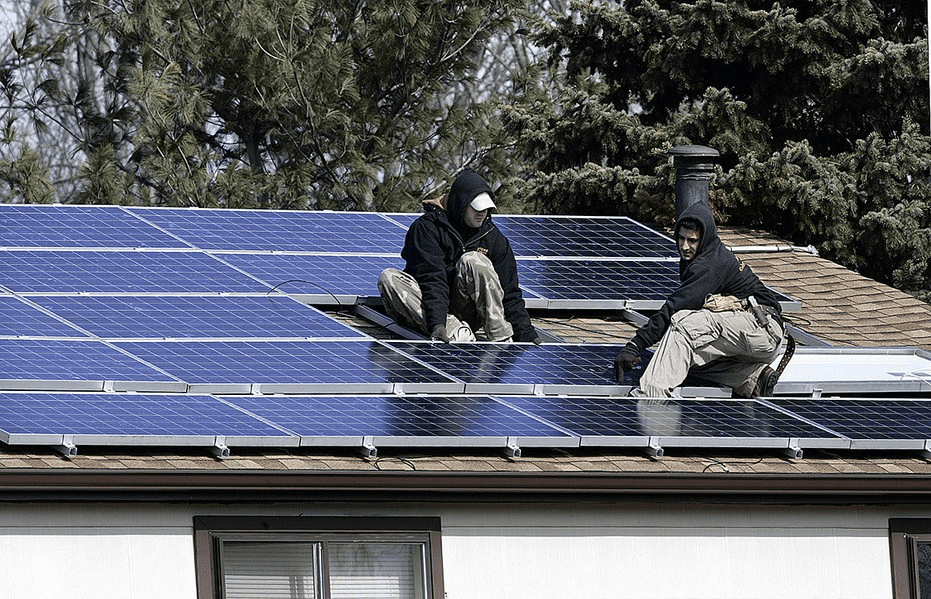 Two solar installers working on a roof in Williamstown, N.J.AP Photo/Mel Evans