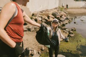 People picking up trash on South Platte River in Denver, CO
